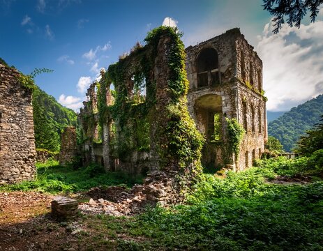 ruins in akarmara town tkvarcheli city abkhazia old destroyed building overgrown by greenery in summer concept of war nature