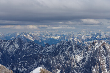 Fototapeta premium Mountain Ranges Covered in Snow with Cloudy Sky