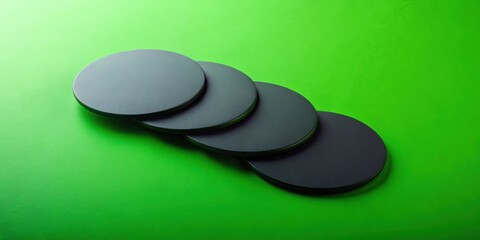Stylish Black Circular Discs Arranged on Vibrant Green Background