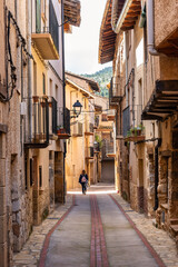 Tourist woman enjoying the old stone houses in the town of Beceite, Teruel.
