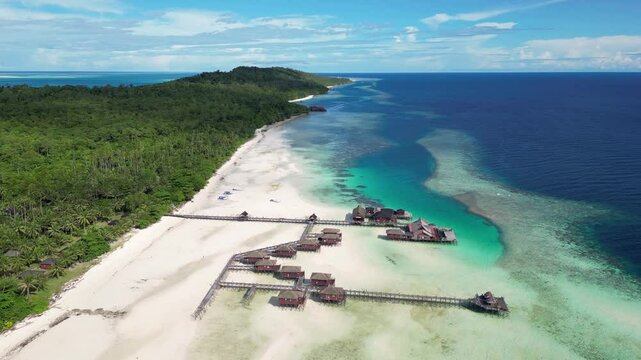Maratua, Indonesia: Aerial drone footage of overwater bungalow in the idyllic Maratua island in the Derawan archipelago in Kalimantan in Indonesian Borneo. 