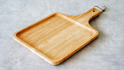 Wooden cutting board on background
