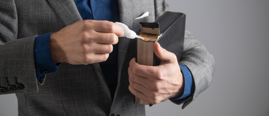 Man glues the book. Repairing and restoration