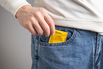 Caucasian man showing condom. Safe sex