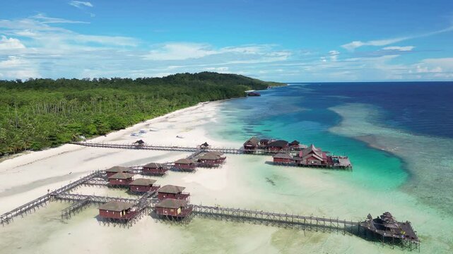 Maratua, Indonesia: Aerial drone footage of overwater bungalow in the idyllic Maratua island in the Derawan archipelago in Kalimantan in Indonesian Borneo. 