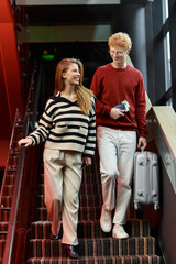 Young couple enjoys romantic moments together while checking into a modern hotel
