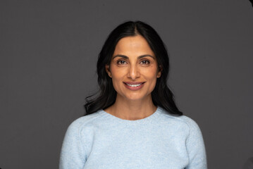Obraz premium Beautiful Asian Indian woman in blue sweater.