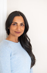 Beautiful Asian Indian woman in blue sweater.