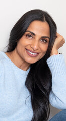 Beautiful Asian Indian woman in blue sweater.