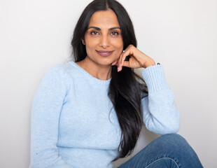 Beautiful Asian Indian woman in blue sweater.