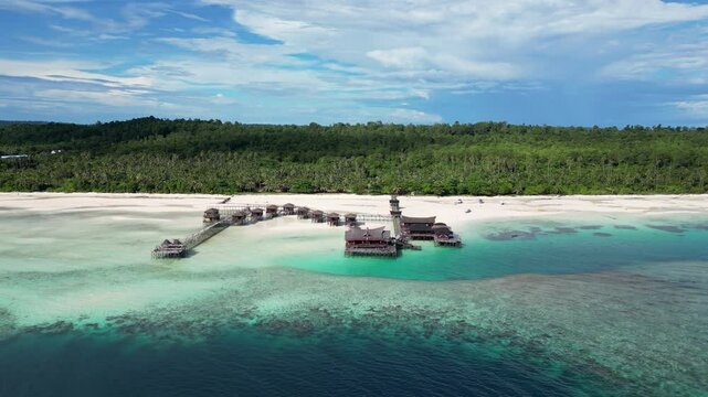 Maratua, Indonesia: Dramatic Aerial drone footage of the coral reef along Maratua island, home of a few luxury resorts, in the Derawan archipelago in east Kalimantan in Indonesia Borneo, with a slide.