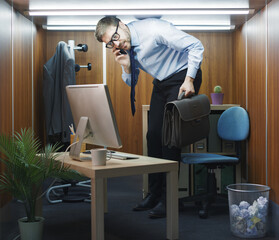 Funny businessman working in a small office