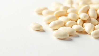 Scattered white beans on pristine white background, texture, culinary arts, photography