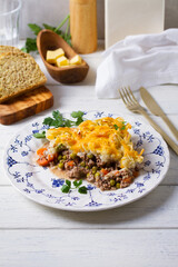 Shepherd's Pie or Cottage Pie on white wooden background. Traditional Irish and British dish