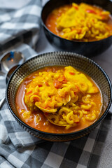 homemade fish and clam noodle casserole recipe in a black bowl