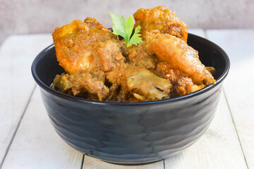 chicken curry food in a bowl on a wooden table