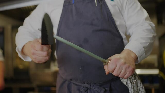 A chef is holding a knife and a sword, preparing to cut something. Concept of skill and precision, as the chef is using both a knife and a sword to cut food