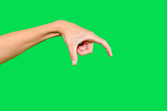Hand forming a gesture demonstrating size on a bright green background, emphasizing creativity and expression in visual communication - Powered by Adobe