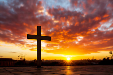 vibrant sunrise behind simple cross,