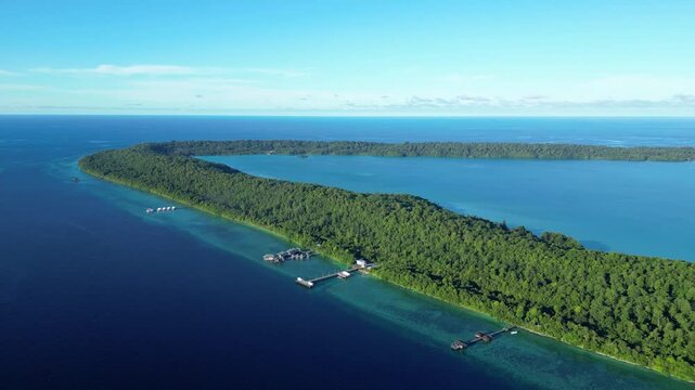 Maratua, Indonesia: Aerial drone footage of resort and overwater stilt bungalow in the with jetty by the reef of the Maratua island in the Derawan archipelago in Kalimantan in Indonesian Borneo. 