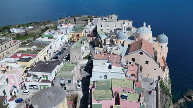 Tilted aerial view of Abbazia di San Michele Arcangelo church and Terra Murrata hill in Procida, a popular holiday island in Italy

