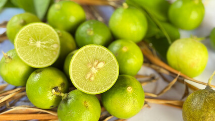 Fresh Green Limes with Slices on Natural Background