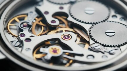Close-up view of intricate watch mechanism with gears and cogs