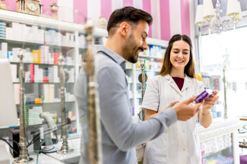 Pharmacy Cashier Recommends Medicine, Professional Pharmacist Dispenses Prescription Medications