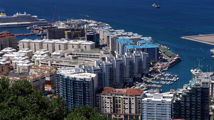Gibraltar cityscape featuring cruise ship and marina from elevated perspective - GIBRALTAR, UK -...
