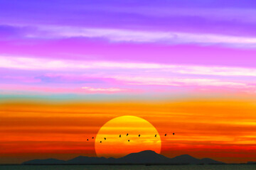sunset colorful purple white pink with silhouette mountain hill near the sea and birds flying back home