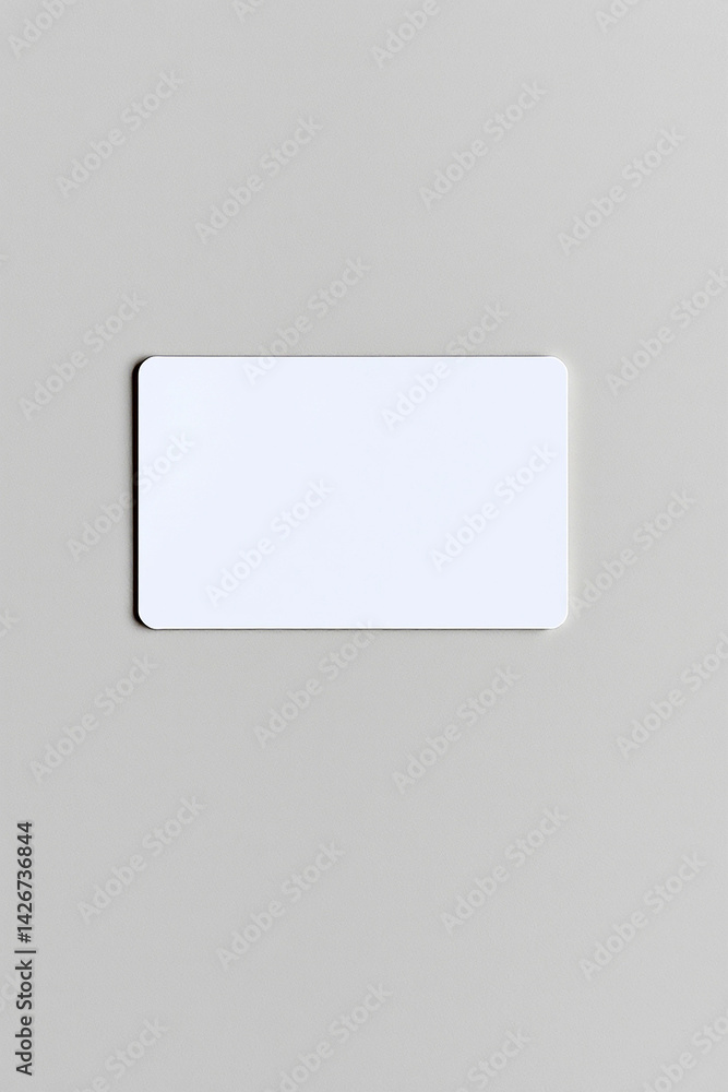 Poster blank white card on light grey surface. clean rectangular object with rounded corners. simple templa