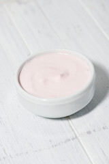 fruit yogurt in a white bowl, vertical