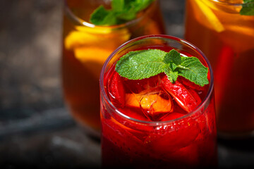 glasses of refreshing cold black and fruit tea, top view