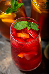 glasses of refreshing cold black and fruit tea, vertical top view