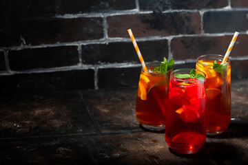 glasses of refreshing iced tea, fruity and black, closeup