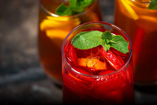 glasses of refreshing cold black and fruit tea, top view