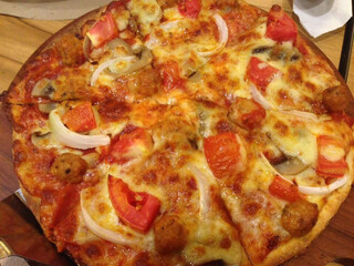 Delicious pizza with ham, mozzarella  served on wooden table