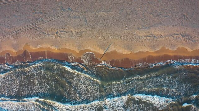 At sunset hours from Iztuzu Beach, the sea dances with the sand; the waves rhythmically move towards the shore. The walking woman turns into an abstract composition with the shadows cast by the sun.