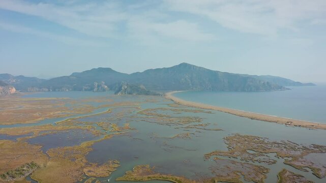 This unique strip of sand, separating the freshwater delta from the salty Mediterranean, is a maze of natural beauty and biodiversity, with majestic mountains and wetlands in the background.