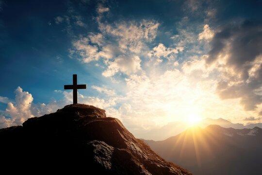 A dramatic sunset illuminates a cross atop a rocky hill, symbolizing faith and hope amidst serene mountain scenery.