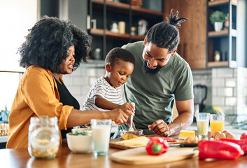 child family kitchen food boy son mother father breakfast preparing egg morning healthy diet eating home black african american father cooking parent cute meal kid