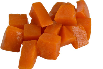 On a white background lies a boiled pumpkin cut into pieces, which will be used to prepare a salad.