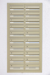 Multiple wall mounted mailboxes outside an apartment building in London