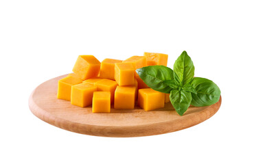 cheddar cheese sliced ​​into cubes on a cutting board isolated on a white background.