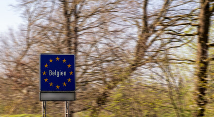 Road sign on the highway indicating the border of a country in the European Union: Belgium. Written in German - Belgium. Copy-space.