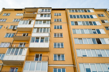 Sunshine reflects off modern apartments in a vibrant urban neighborhood, showcasing life in a bustling city atmosphere