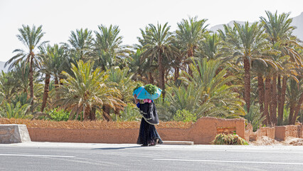 Tradition and effort, woman transporting the harvest in rural Morocco