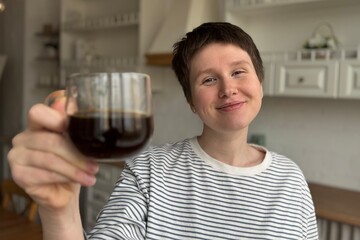 A Joyful Woman Enjoying Her Coffee in a Bright, Modern Kitchen that Feels Cozy and Inviting