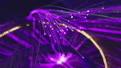 Fiber optic lamp shining with purple light. Action