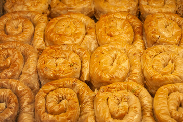 Traditional Middle Eastern baklava rolls with golden, flaky layers.
